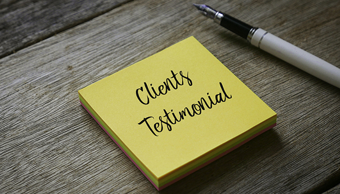 yellow post it note with "client testimonials" written on it
